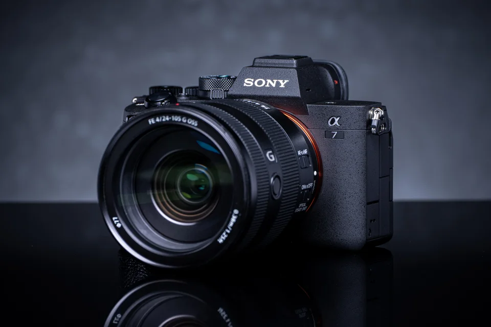 Sony a7 IV with a 24–105mm lens against a dark studio background